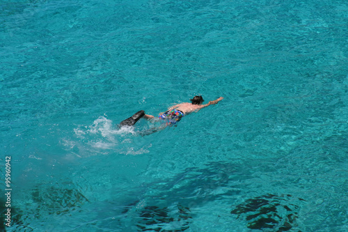 Young boy snorkeling in crystal clear water of Blue Lagoon  Comino Malta .
