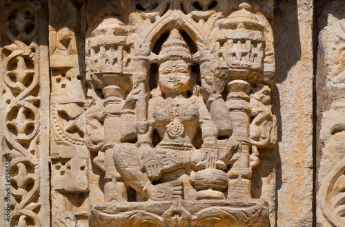 Stone relief with Hindu god on the front of indian temple