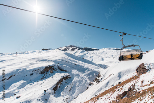 Ski lifts durings bright winter day