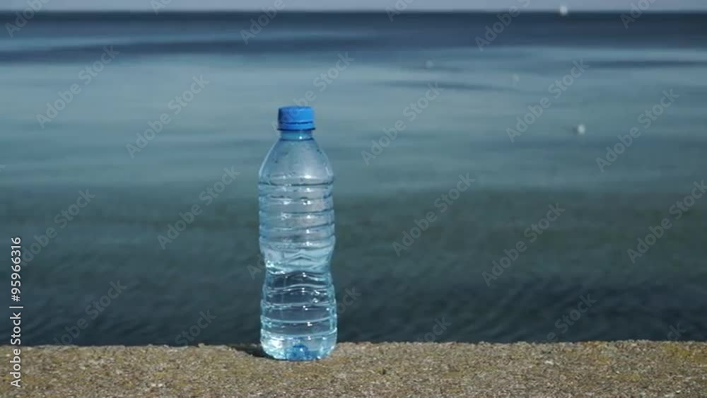 Water plastic bottle outdoor on sea shore 4K Water plastic bottle outdoor on sea shore 4K