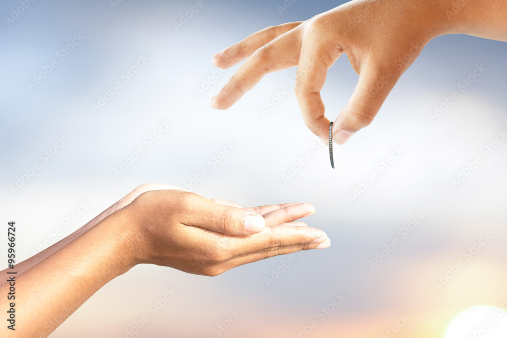 Naklejka premium hand gives money to the poor.