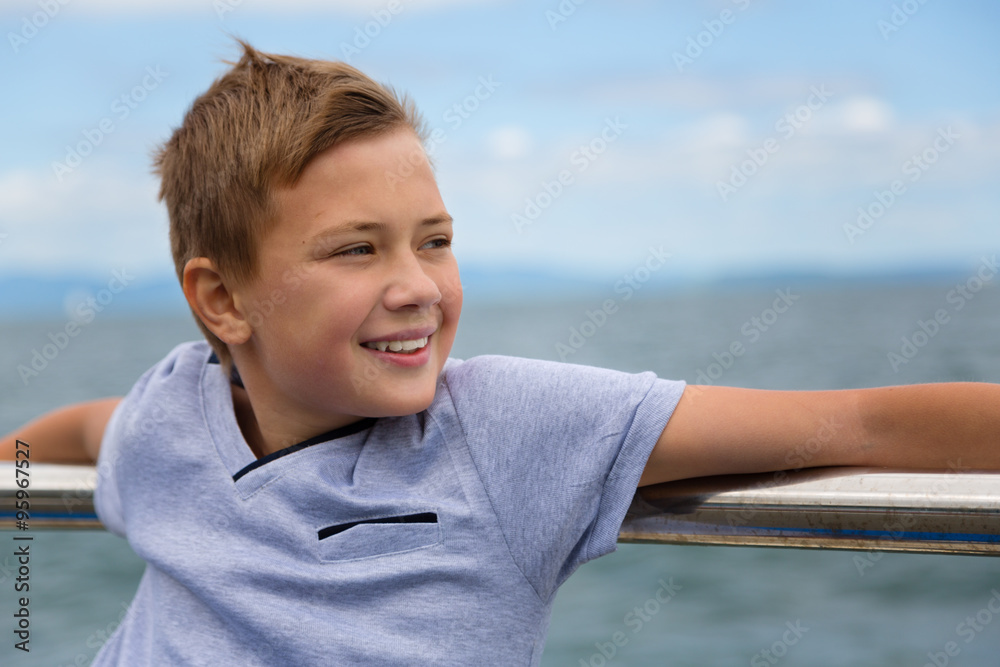 Smiling boy on the promenade by sea Smiling boy on the promenade by sea