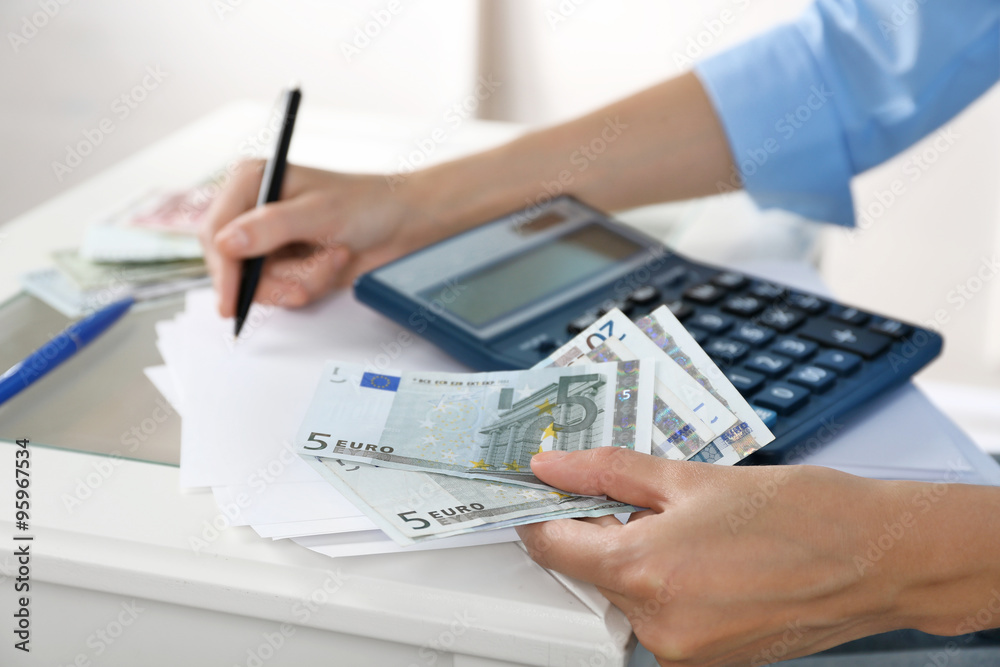 Fototapeta premium Accounting concept.Analyzing finance report with calculator