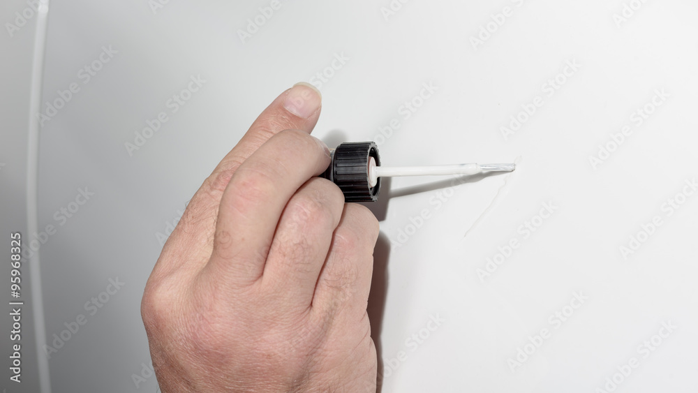 Touch up paint brush fixes a scratch on car Touch up paint brush fixes a scratch on car