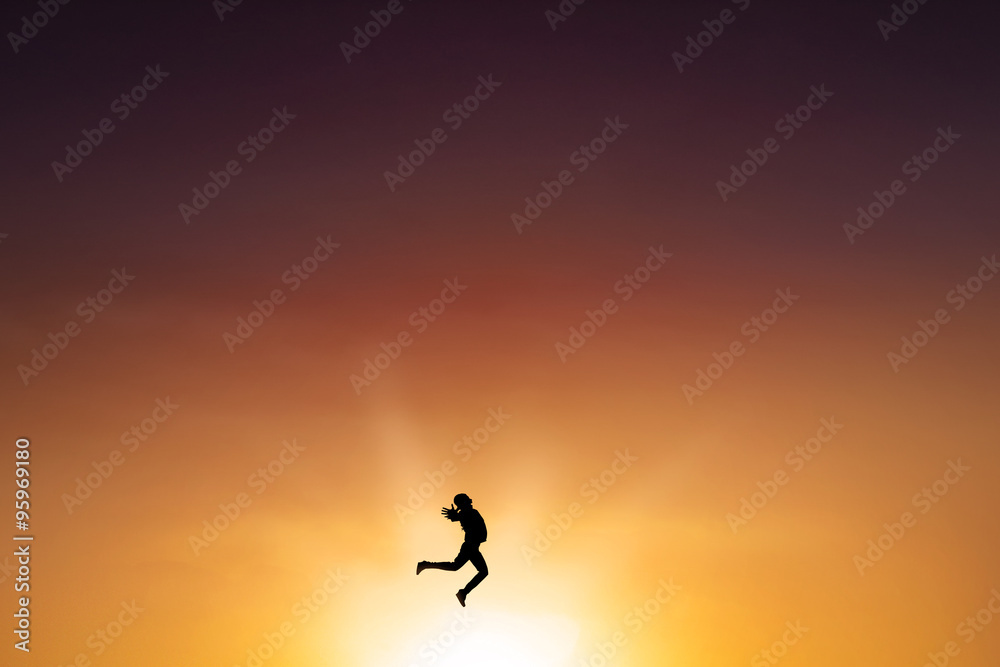 Successful woman leaps on the air at dusk time