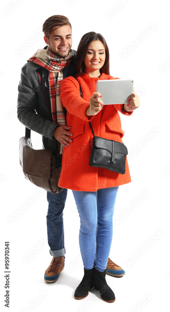 A pair of happy tourists sightseeing in spring/autumn, isolated on white A pair of happy tourists sightseeing in spring/autumn, isolated on white