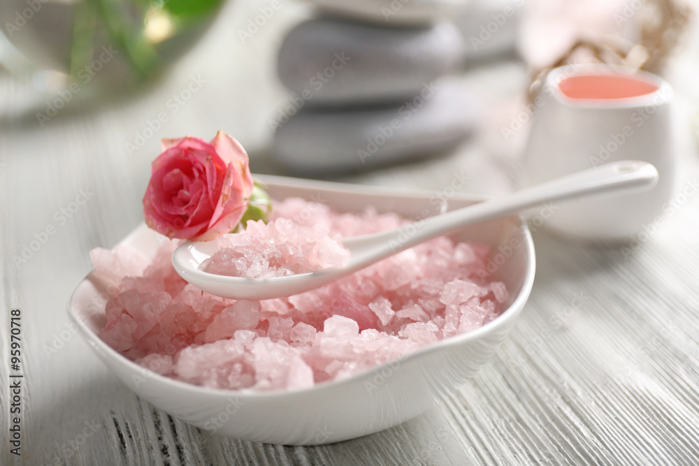 Composition of flowers, salt and stones on white wooden background, in spa salon Composition of flowers, salt and stones on white wooden background, in spa salon