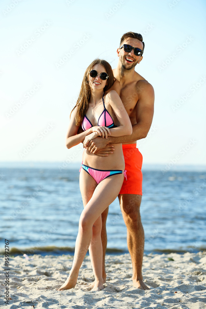 A guy hugging a girl at the beach, outdoors A guy hugging a girl at the beach, outdoors