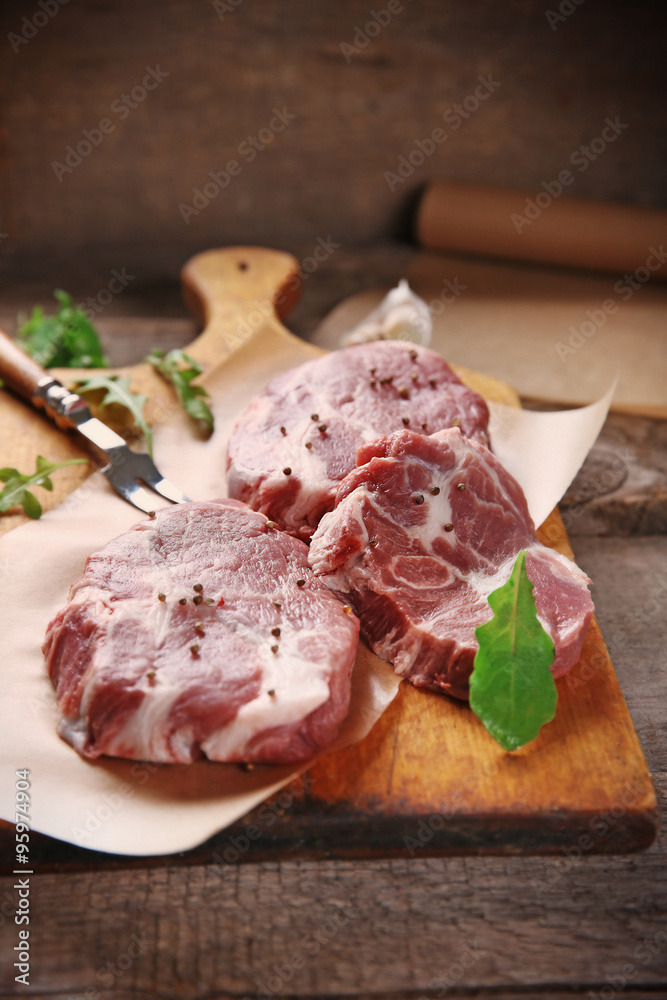 Marbled beef steak and spices on wooden background