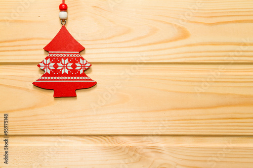 Christmas wooden background decorated with a toy.