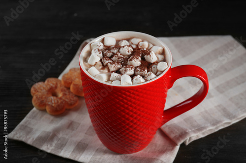 A cup of tasty cocoa and marshmallow on the table