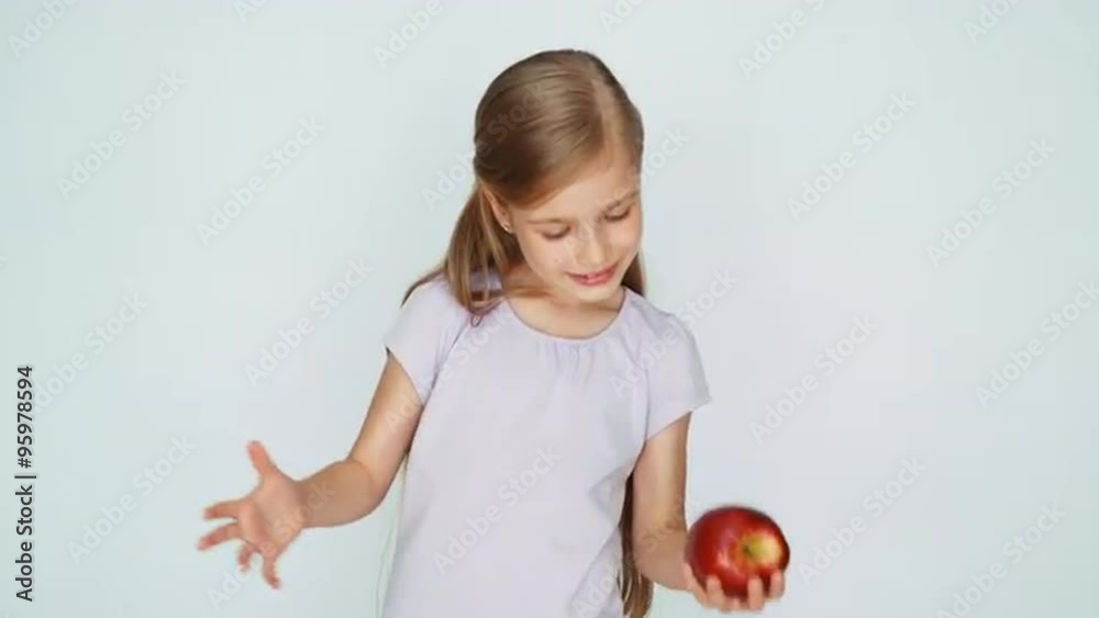 Girl playing with apple and laughing. Thumb up. Ok Girl playing with apple and laughing. Thumb up. Ok