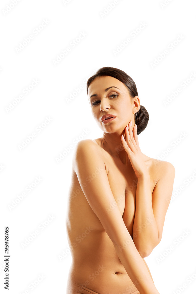 Obraz premium Nude woman sitting on desk, covering her breast