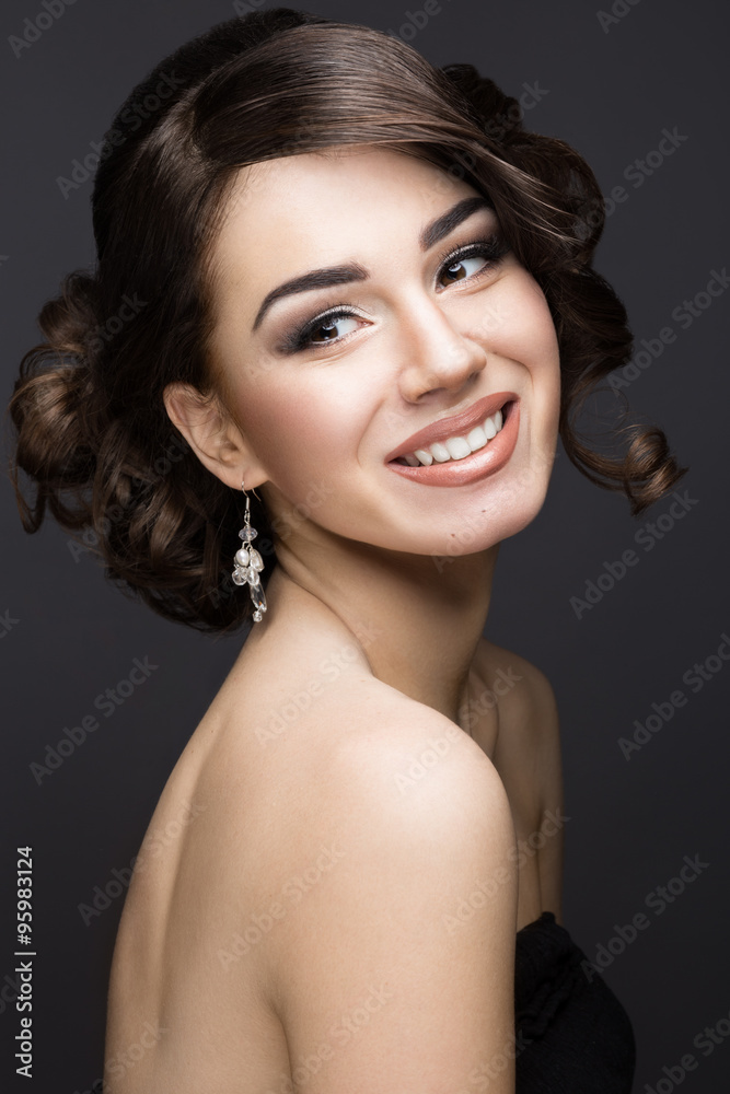 Beautiful brunette girl with perfect skin, evening make-up, wedding hairstyle and accessories. Beauty face Beautiful brunette girl with perfect skin, evening make-up, wedding hairstyle and accessories. Beauty face