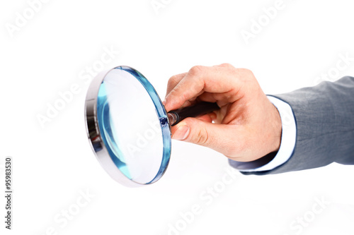 Magnifying glass in hand isolated over white background