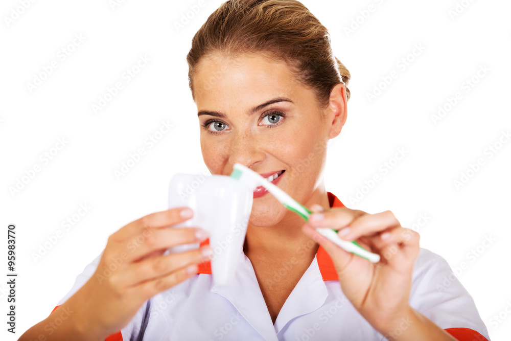 Young dentist woman with toothbrush and tooth model Young dentist woman with toothbrush and tooth model