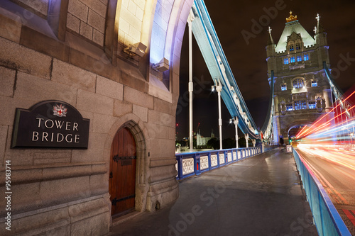 Tower bridge in London illuminated at night with car passing lights #95983714