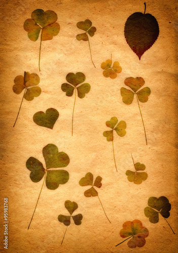 Sepia Vintage card with Leaf clover and Old Paper Texture.