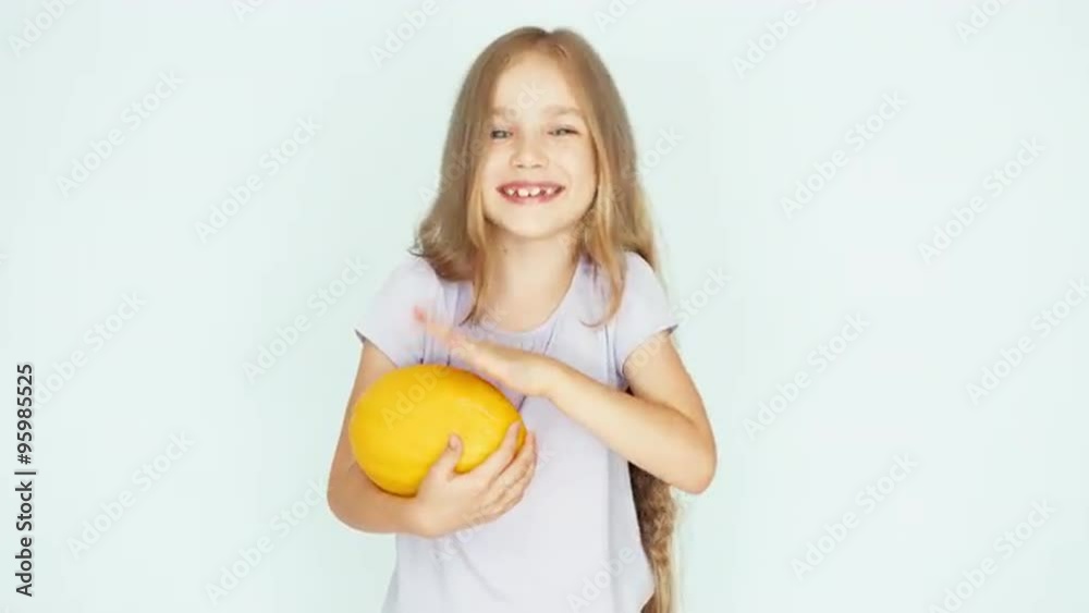 Girl playing with melon and laughing at camera on the white background. Thumb up. Ok Girl playing with melon and laughing at camera on the white background. Thumb up. Ok