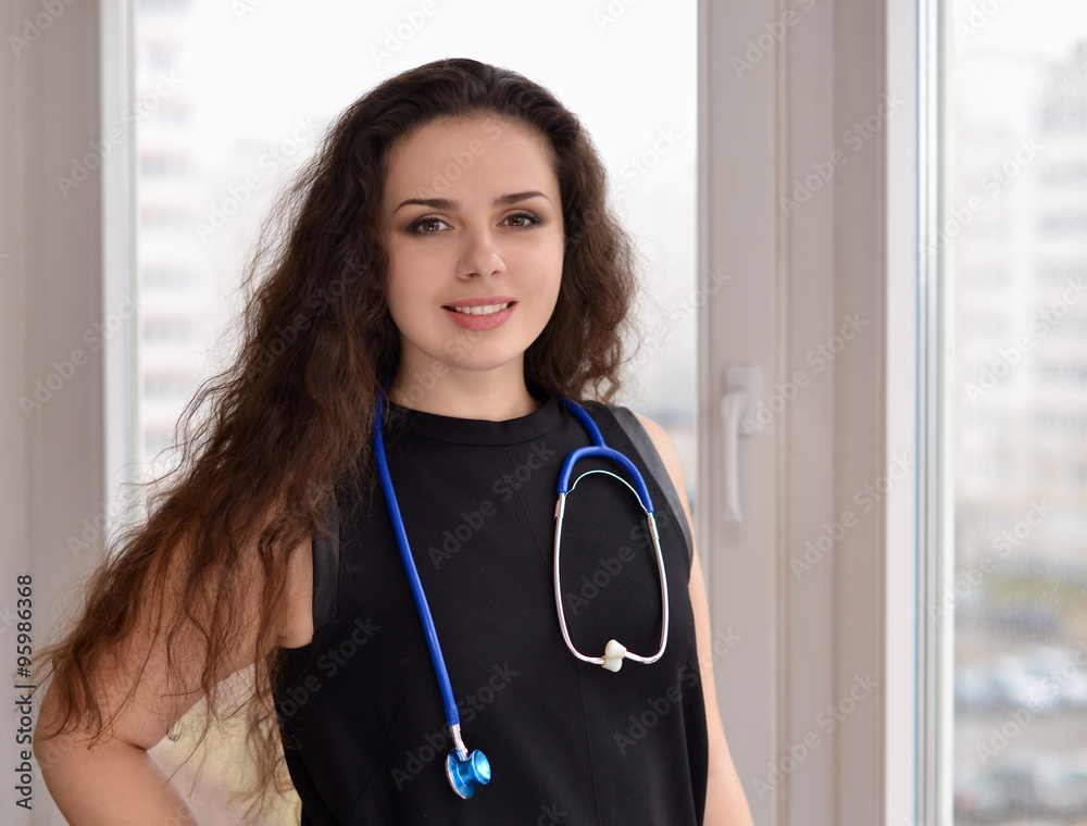 Portrait of young woman doctor standing near window Portrait of young woman doctor standing near window