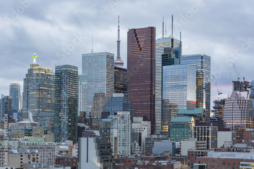 Toronto Financial District skyscrapers and the CN Tower apex on the background at sunset