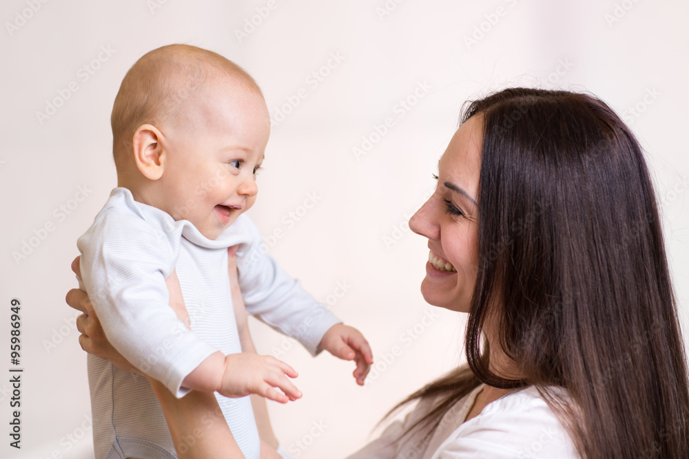 Mom holding smiling baby boy