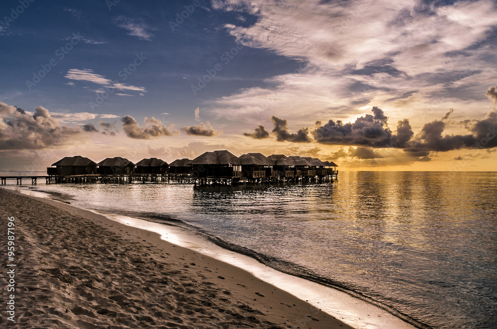 Maldives at sunset. Water bungalows at sunset