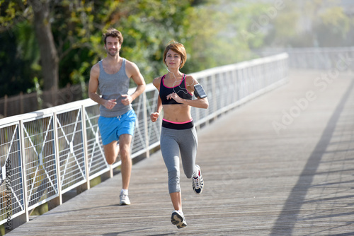 Couple running on riverside