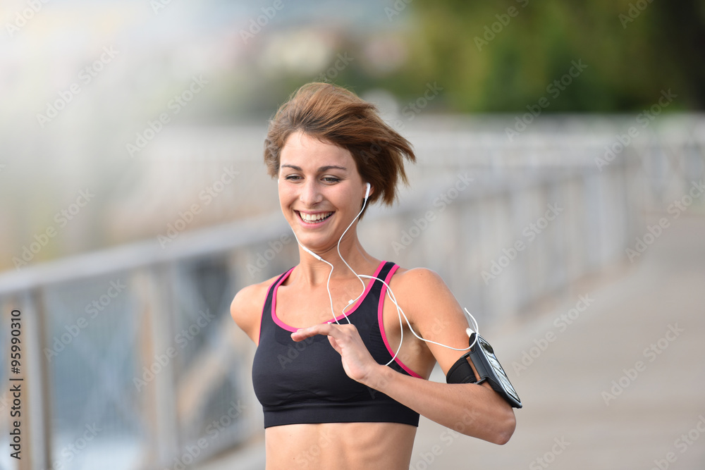 Cheerful athletic girl running outside