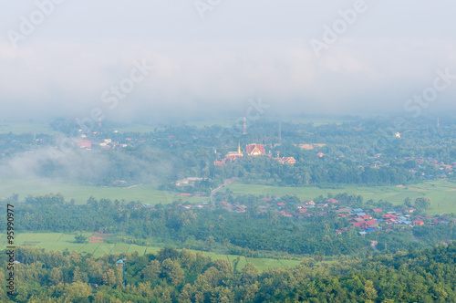 Wat Phra That Cho Hae with Fog on early morning Looking from Wat Pra That Doi Leng View Point at Phrae Province, Thailand. © phollapat
