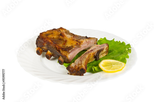 The ribs of wild boar grill on the plate, isolated