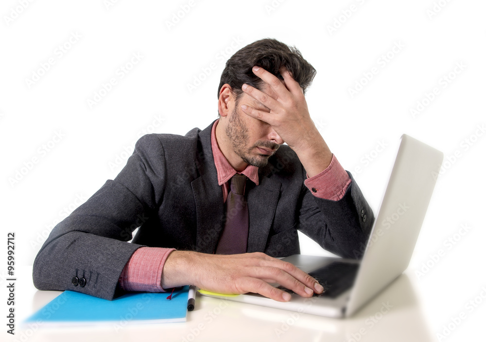 young businessman sitting at office desk working on computer laptop desperate worried in work stress young businessman sitting at office desk working on computer laptop desperate worried in work stress