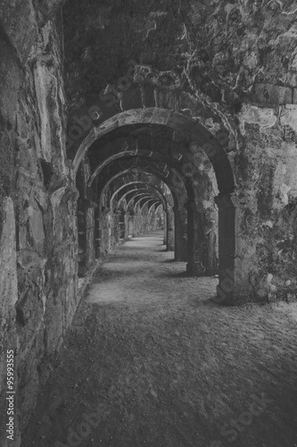 Internal passages in the ancient Roman amphitheater of Aspendos. The province of Antalya. Mediterranean coast of Turkey. Black and white. Stylization.