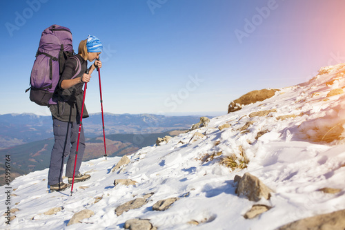 Climber with a backpack is on a slope.