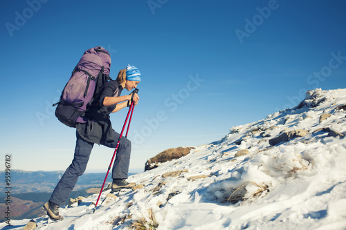 Tourist with a backpack is the snowy slope.