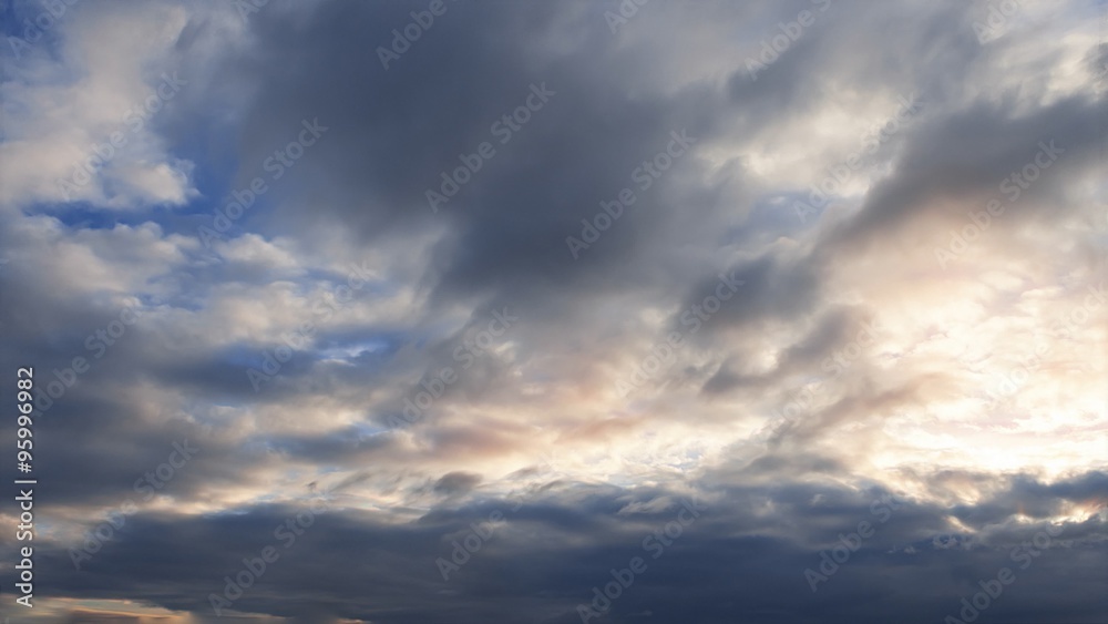 Beautiful evening clouds time-lapse with sunset from day to night. Clear crisp cloudscape with large, building clouds and light rays with sun flare, perfect for digital cinema composition. Beautiful evening clouds time-lapse with sunset from day to night. Clear crisp cloudscape with large, building clouds and light rays with sun flare, perfect for digital cinema composition.