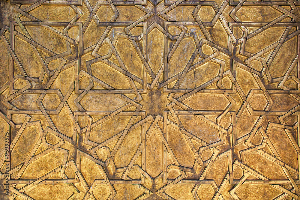 Intricate oriental golden pattern in Fes, Morocco.