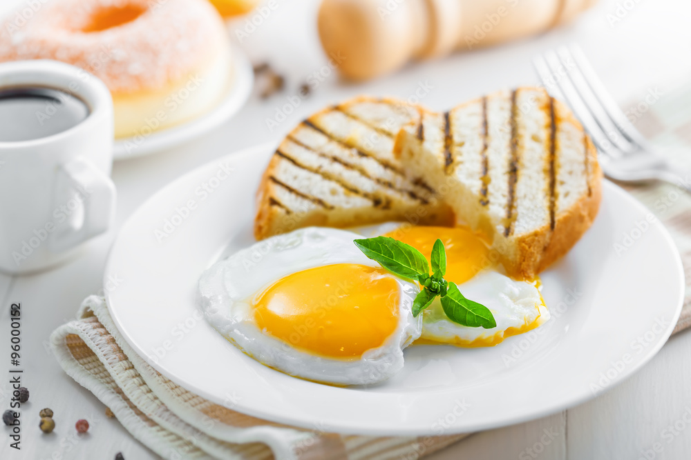 Breakfast with fried eggs, coffee and dessert on table. Healthy food Breakfast with fried eggs, coffee and dessert on table. Healthy food