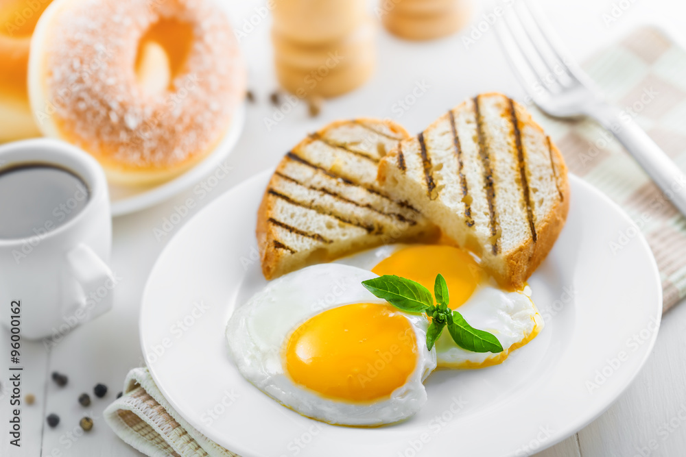Fotografie Fried eggs with coffee and dessert on breakfast