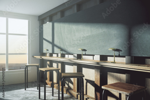 Modern college classroom with blank blackboard and window in flo