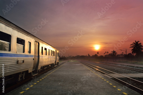 Train running in sunset