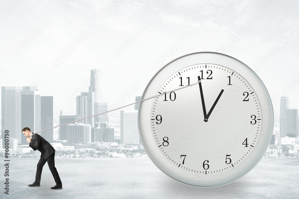 Businessman trying to return the time with rope, stop the time c Businessman trying to return the time with rope, stop the time c
