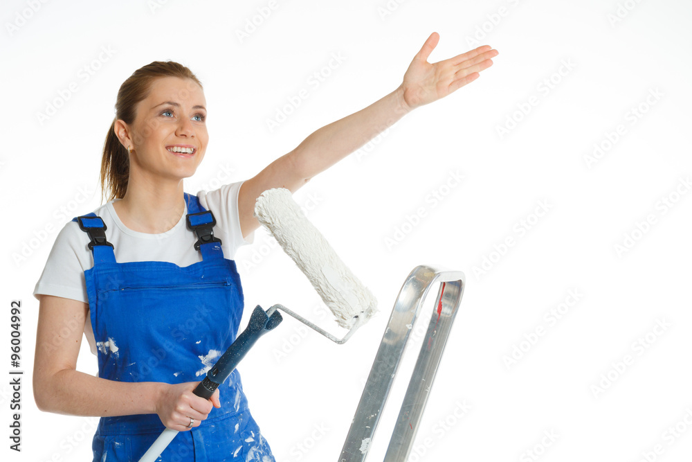 Beautiful young woman doing repairs in blue coverall Beautiful young woman doing repairs in blue coverall