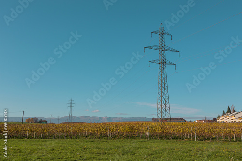 metal poles for power lines in a field outside the city in the summer day. industrial construction.