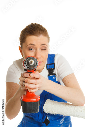strong funny woman in coverall with drill