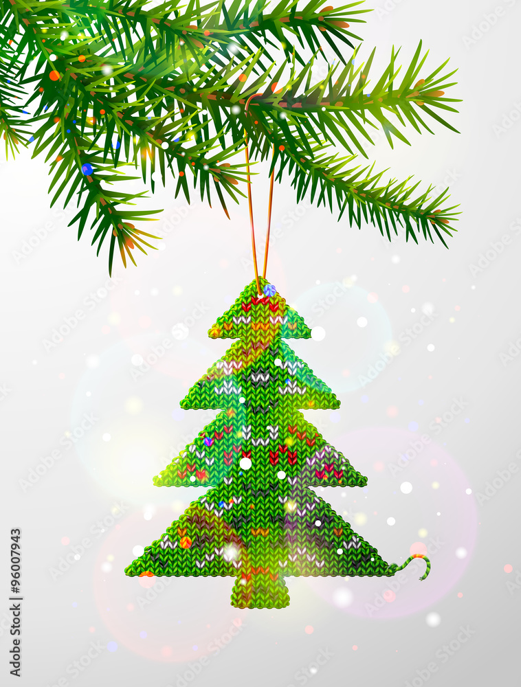 Fototapeta premium Christmas tree branch with hanging knitted pine as bauble