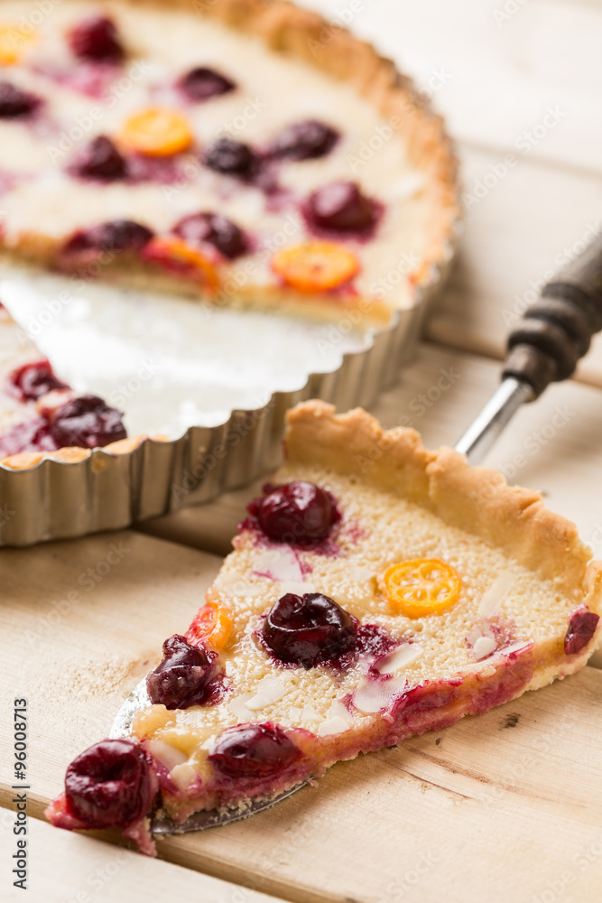 Baked tart with cherry and physalis slices in baking pan Baked tart with cherry and physalis slices in baking pan