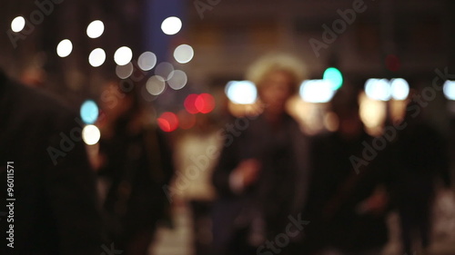 slow motion of people crossing the street in a out of focus blurred background in a context city photo