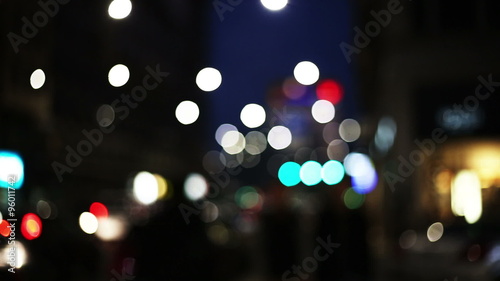 slow motion of anonymous people walking in the street in a big city with colored out of focus context photo