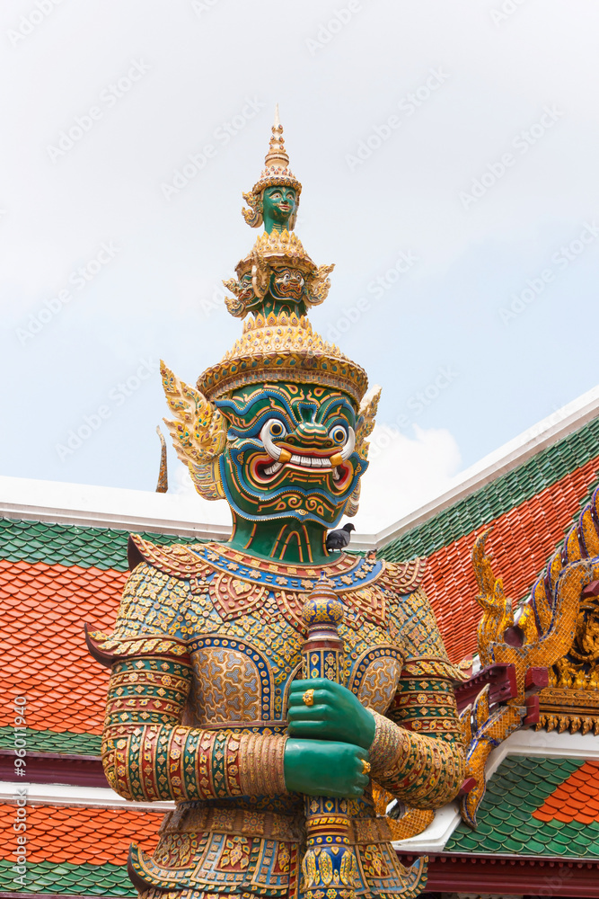 Green Thai giant demon Yaksha statue at Wat Phra Kaew temple in Bangkok Thailand.